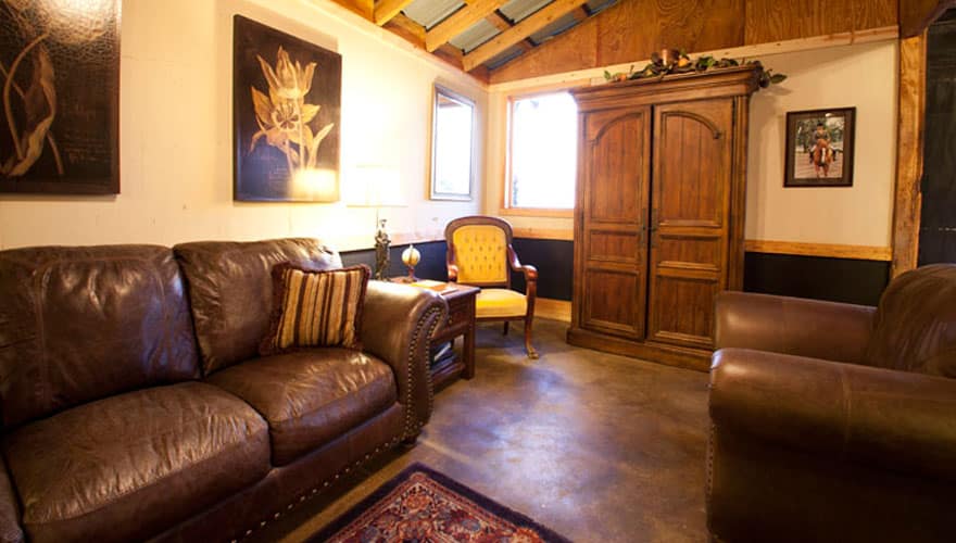 Seating area with leather sofas inside the Lindsey Plantation stables